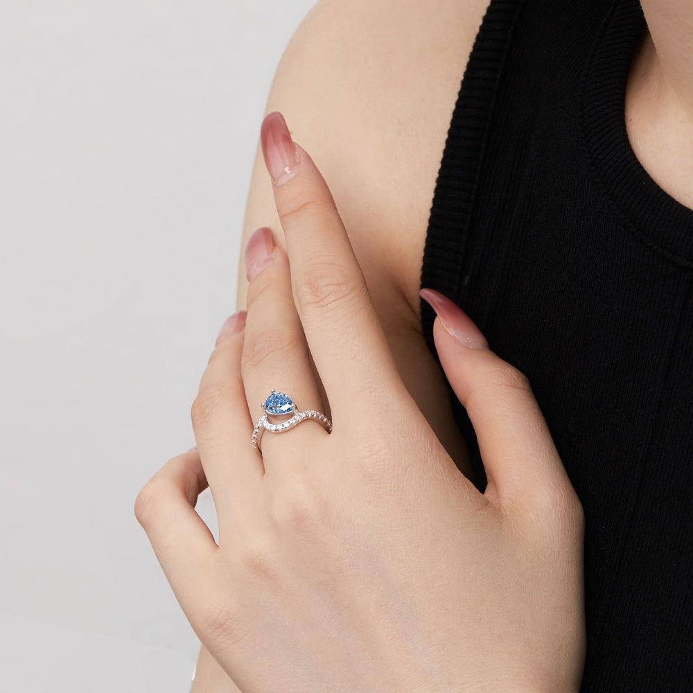 Image of someone wearing a Blue Tears ring on middle finger