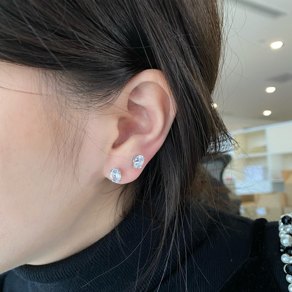 An image of one wearing crystal stud earrings