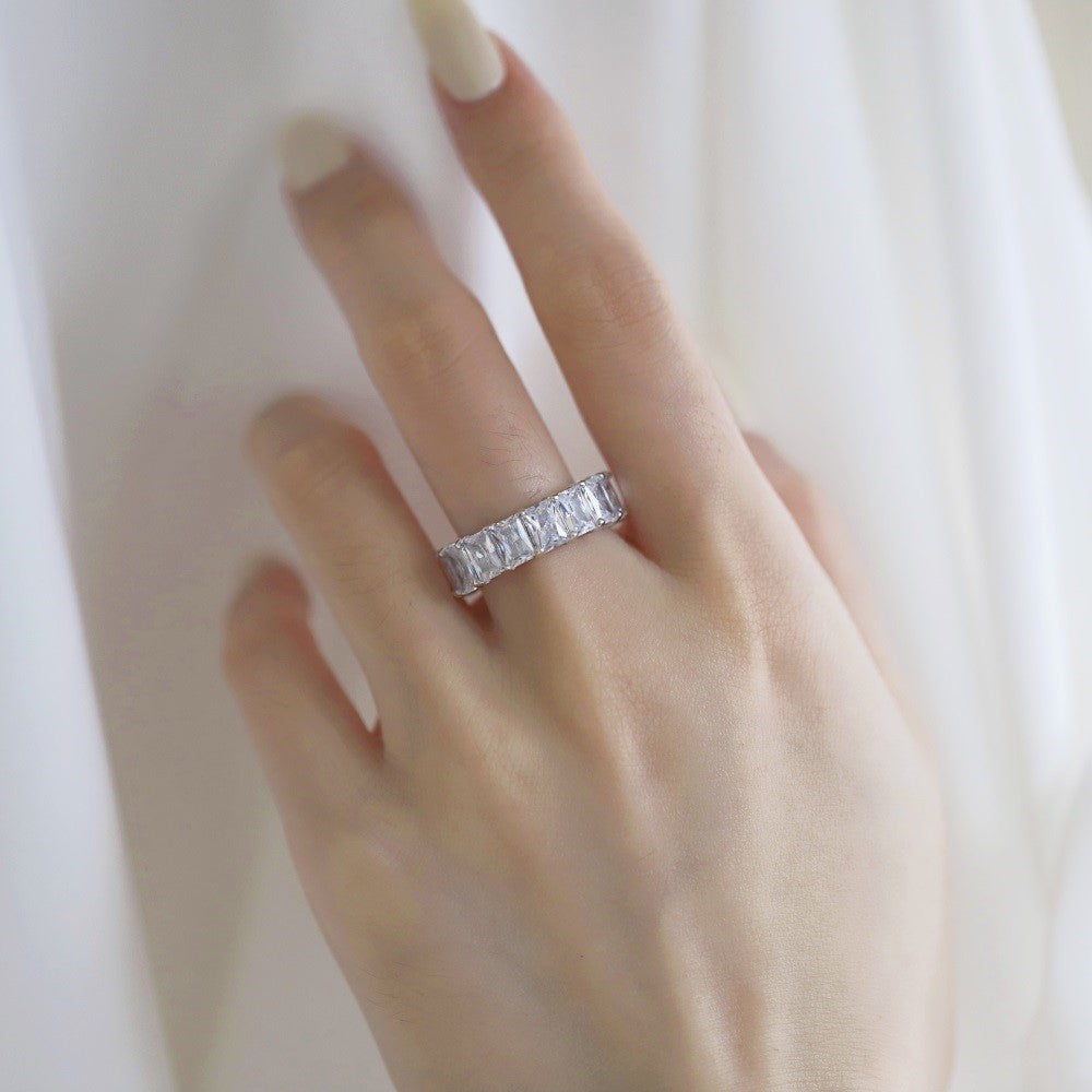 A close-up image of a Kylie ring on a woman's finger