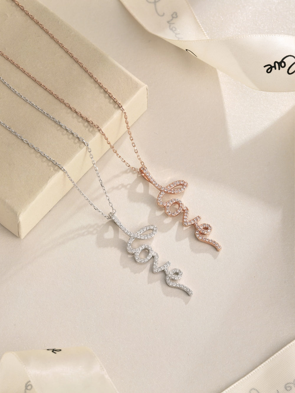 An image showing 2 different Love necklaces