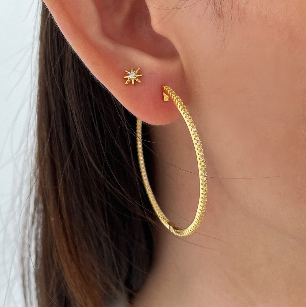 A picture of someone wearing Mia Hoop earrings