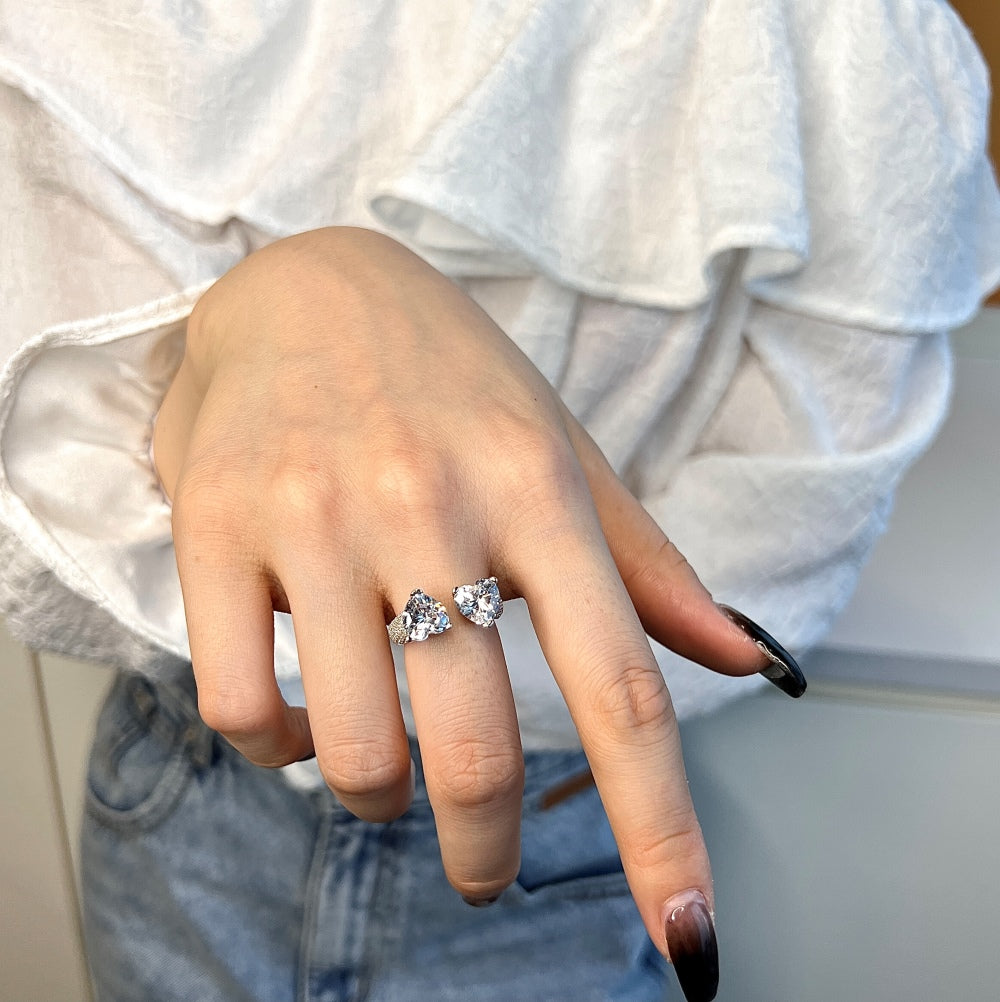 A close up view of the Myra ring on a middle finger